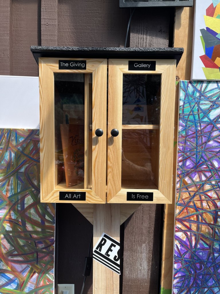Giving Gallery cabinet with Gallery, Giving, Is Free, and Art labels