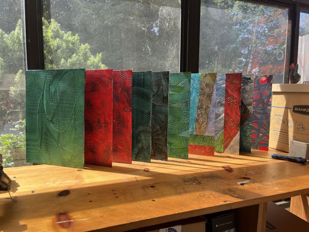 Red and green Art Abandonment panel works arranged in the studio
