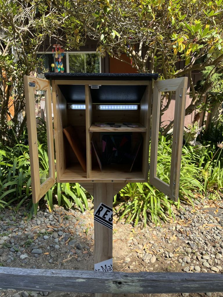 Wooden Giving Gallery cabinet positioned at its outdoor installation site