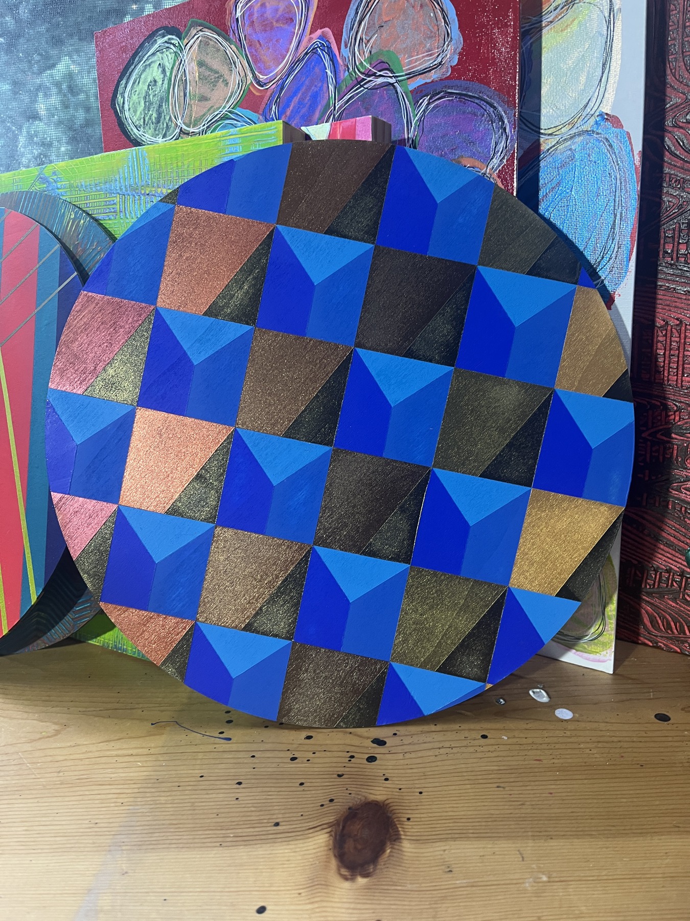 Art Drop #15 (estimated match): Geometries series: circular panel with blue, black, and gold geometric blocks