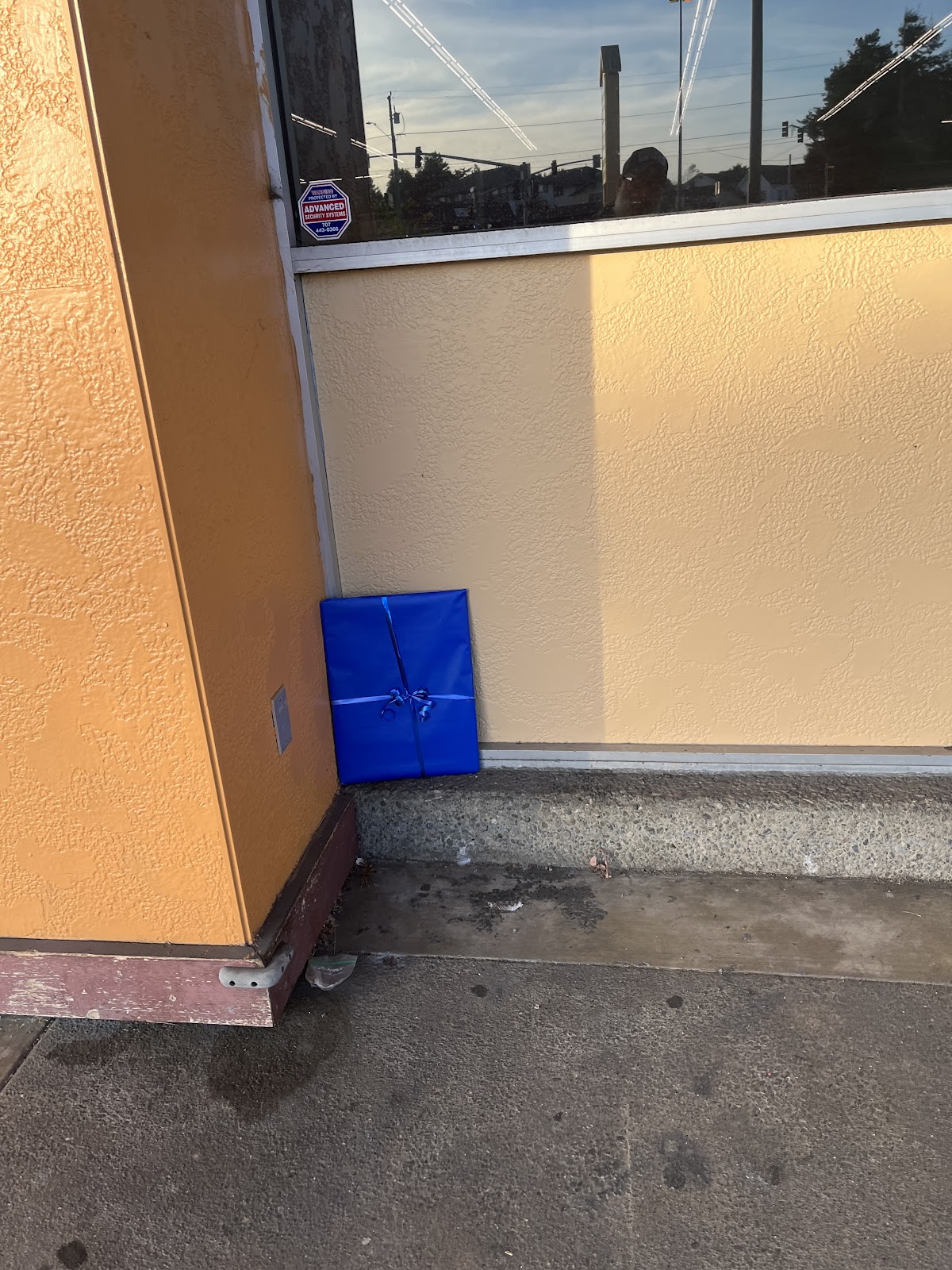 Gift-wrapped artwork placed outside a commercial building for Art Drop #5